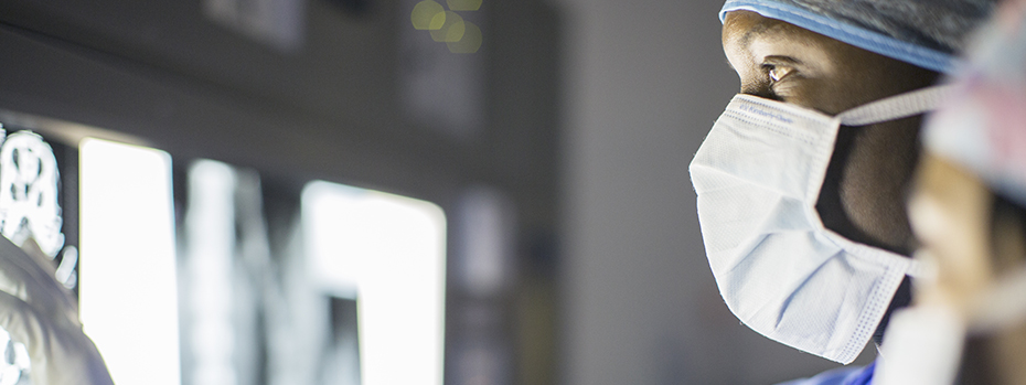 A radiology technologist examines a detailed image of a patient’s brain.