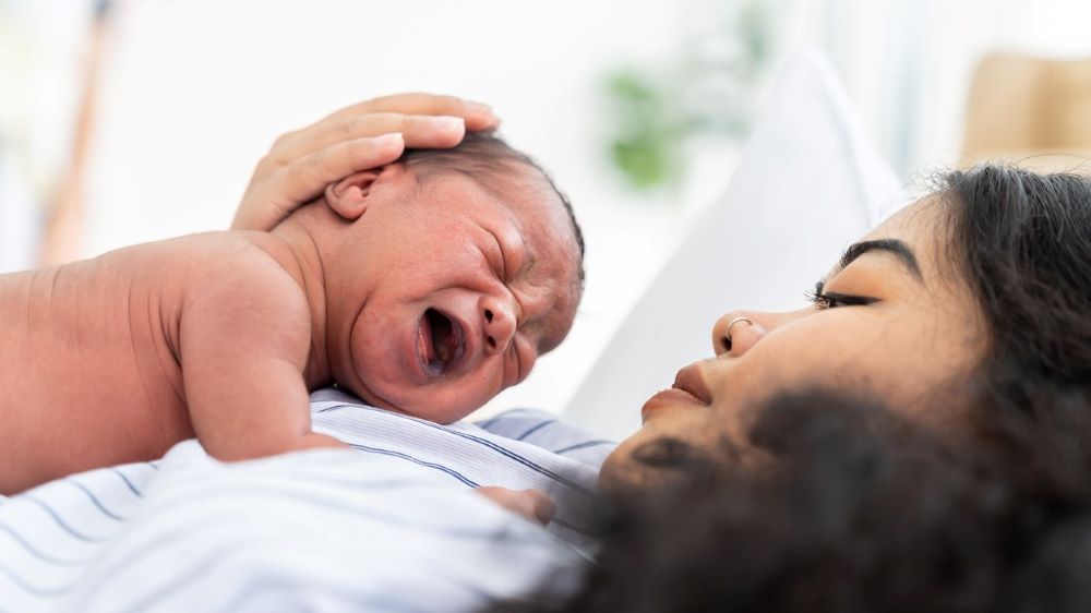 Mom greets her newborn baby