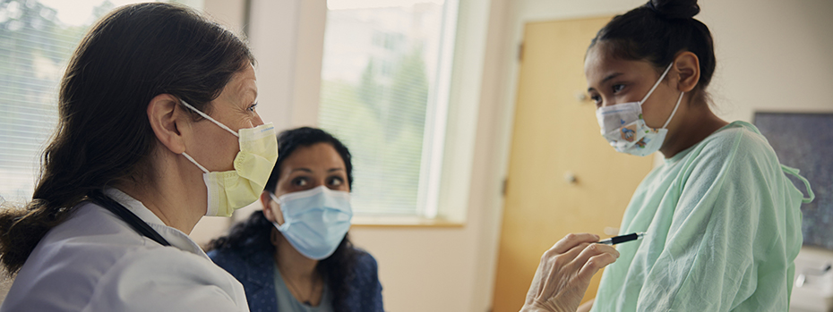 Dr. Bohun talks with a patient and her parent during an exam.