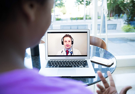A patient chats with her doctor during a virtual visit.