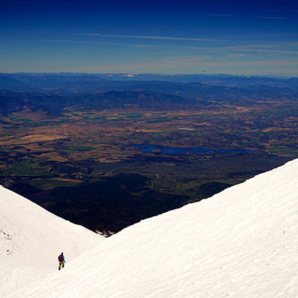 hiker between two mountain peaks