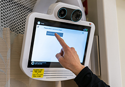 A nurse taps on the communication screen to reach OHSU’s virtual ICU.