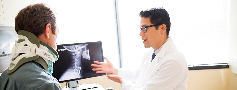 Orthopaedic surgeon Dr. Clifford Lin discusses X-ray with patient