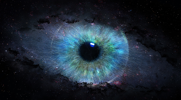 An colorful iris and pupil in surrounded by what looks like outer space