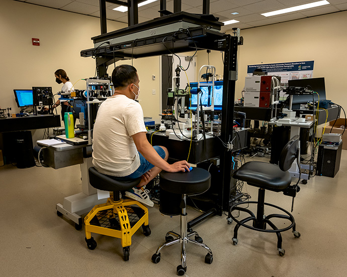 Researchers work in a lab developing ophthalmic imaging technology and devices.