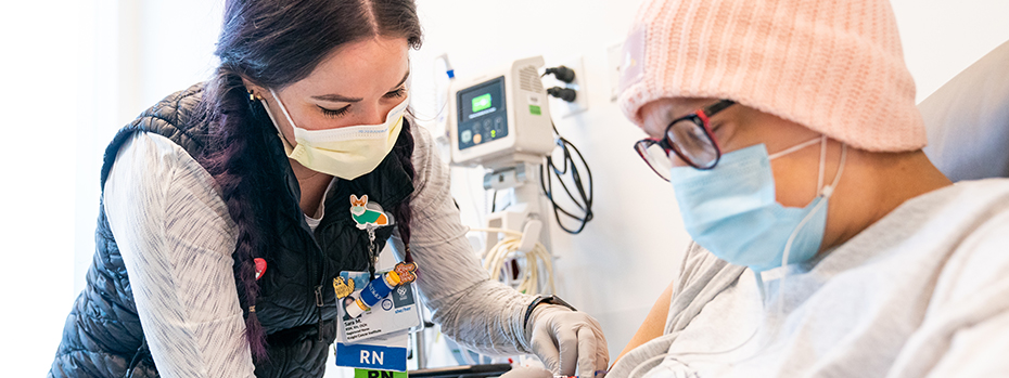 An OHSU nurse treats a patient in the critical care unit