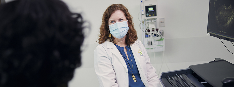 Dr. Baldwin shows a patient an image of a uterus.