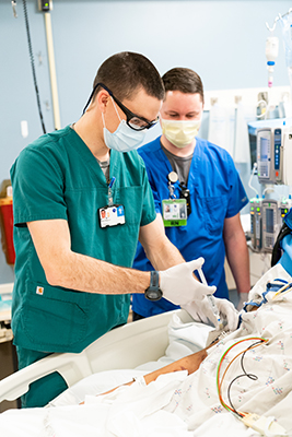 A student nurse is guided by an experienced RN while giving a patient an injection.