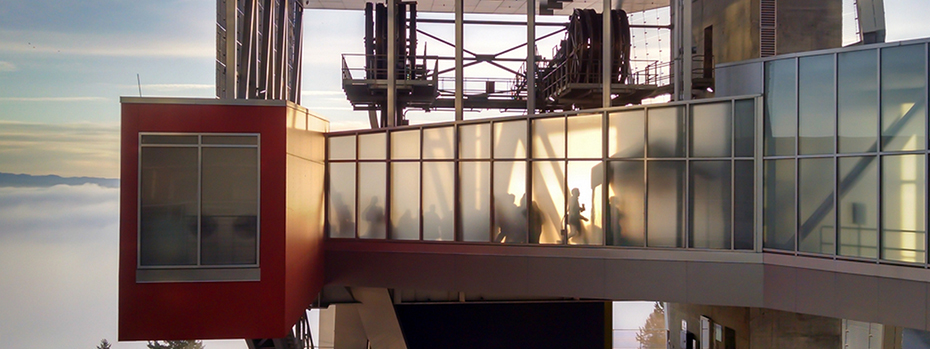 View through the slightly opaque glass walls of a corridor suspended in air with the horizon in the background