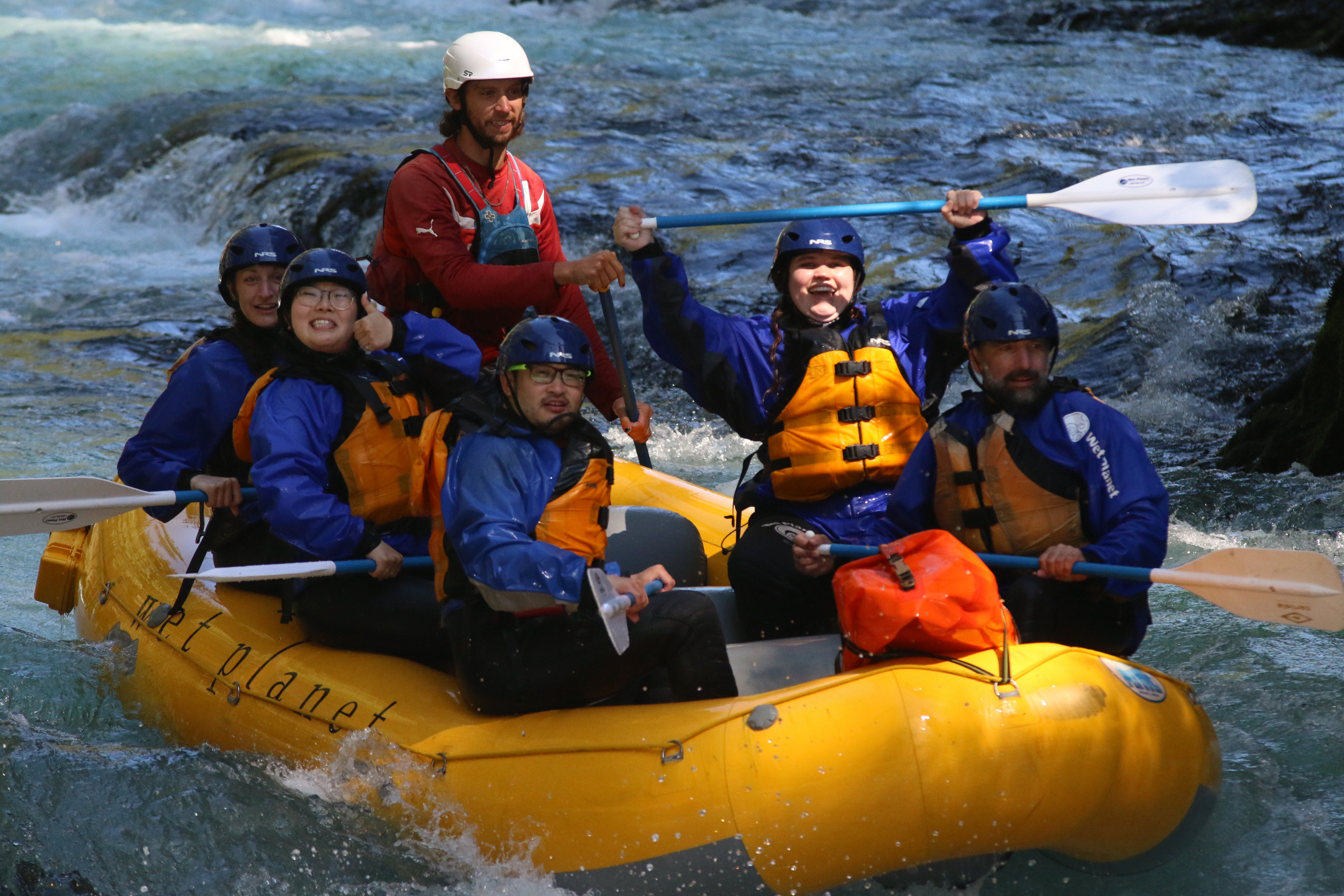 group of adults white water rafting