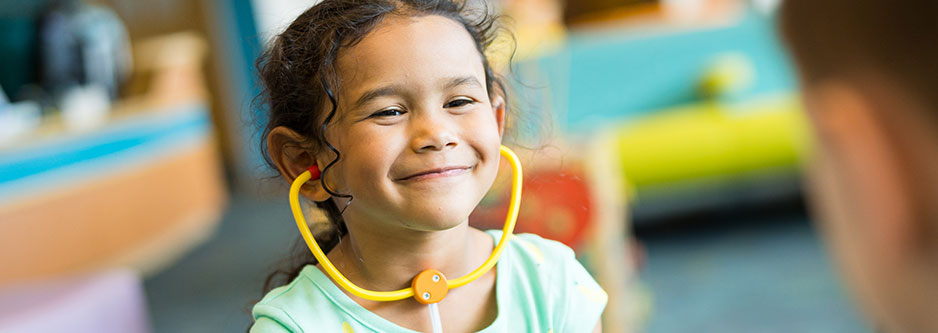 A child wearing a toy stethoscope. 