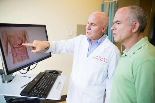 Dr. Michael Heinrich with a patient.