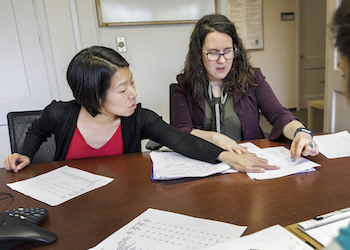 A graduate student in the OHSU-PSU School of Public Health reviews documents with a faculty mentor.
