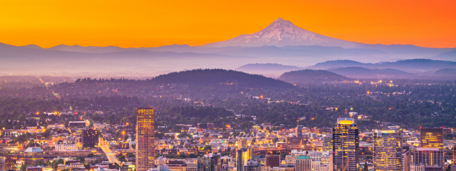 The Portland skyline at sunset, with Mt Hood in the far background.