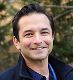 A close-up photo of Dr. Aaron Grossberg smiling outside.