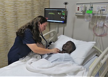 A nursing student at OHSU’s campus in Ashland practices her skills on a realistic mannequin.