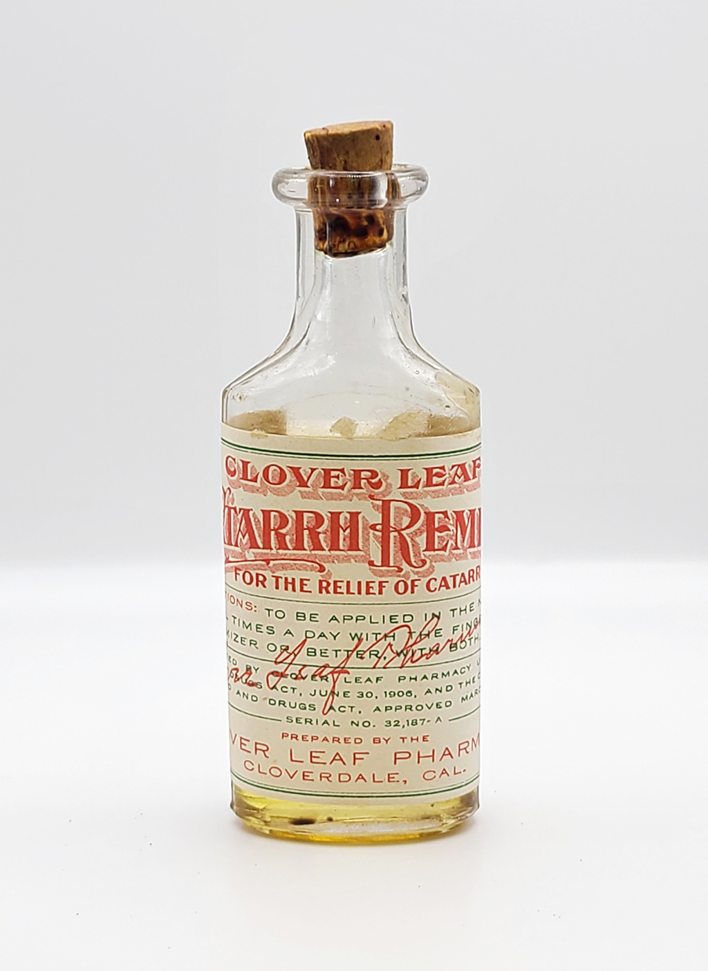 Clear bottle displays the label "Clover leaf catarrh remedy"