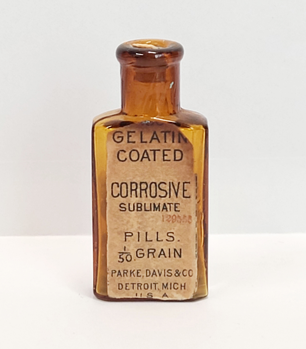An orange bottle displays a label for "Gelatin coated corrosive sublimate" pills