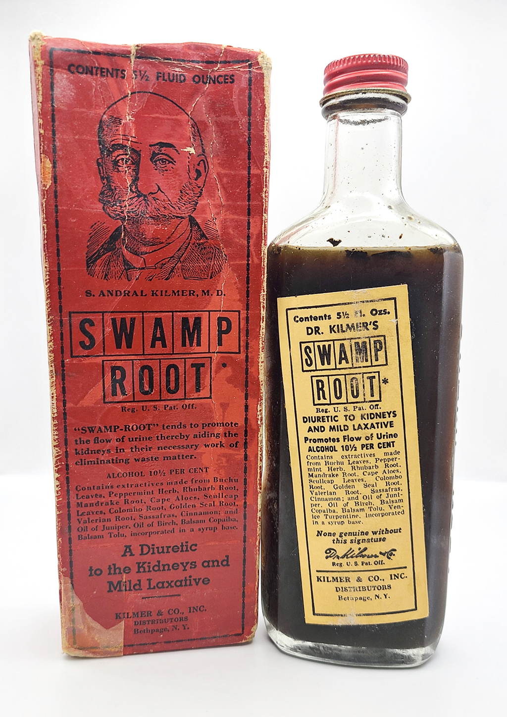 A red bottle with a face and the title "swamp root" sits next to a bottle filled with brown liquid with a matching label