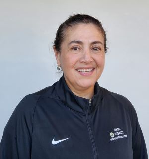 Picture of Norma Sanchez wearing a navy march wellness jacket