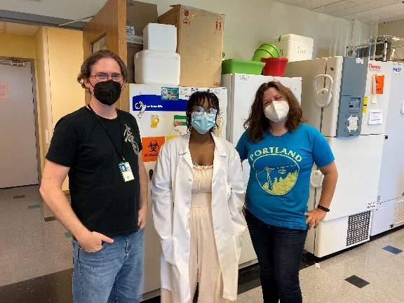 Three members of the Nora Gray lab, posed in the lab