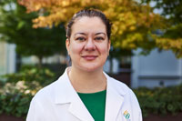 An OHSU provider standing outside in her whitecoat.