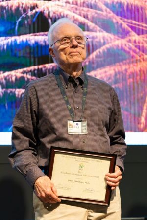 Dr. Jim Huntzicker, Ph.D., M.M., accepts Excellence in Education Award