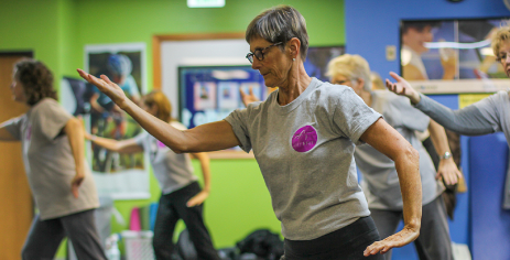 Older adults doing arm exercises in a group fitness class