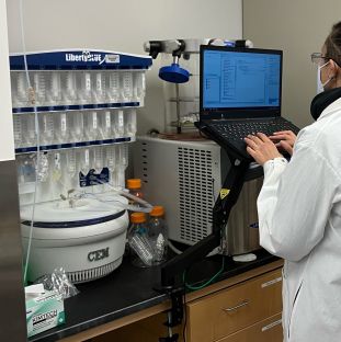 Person operating the Automated Microwave Peptide Synthesizer