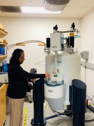 NMR machine with person loading a sample