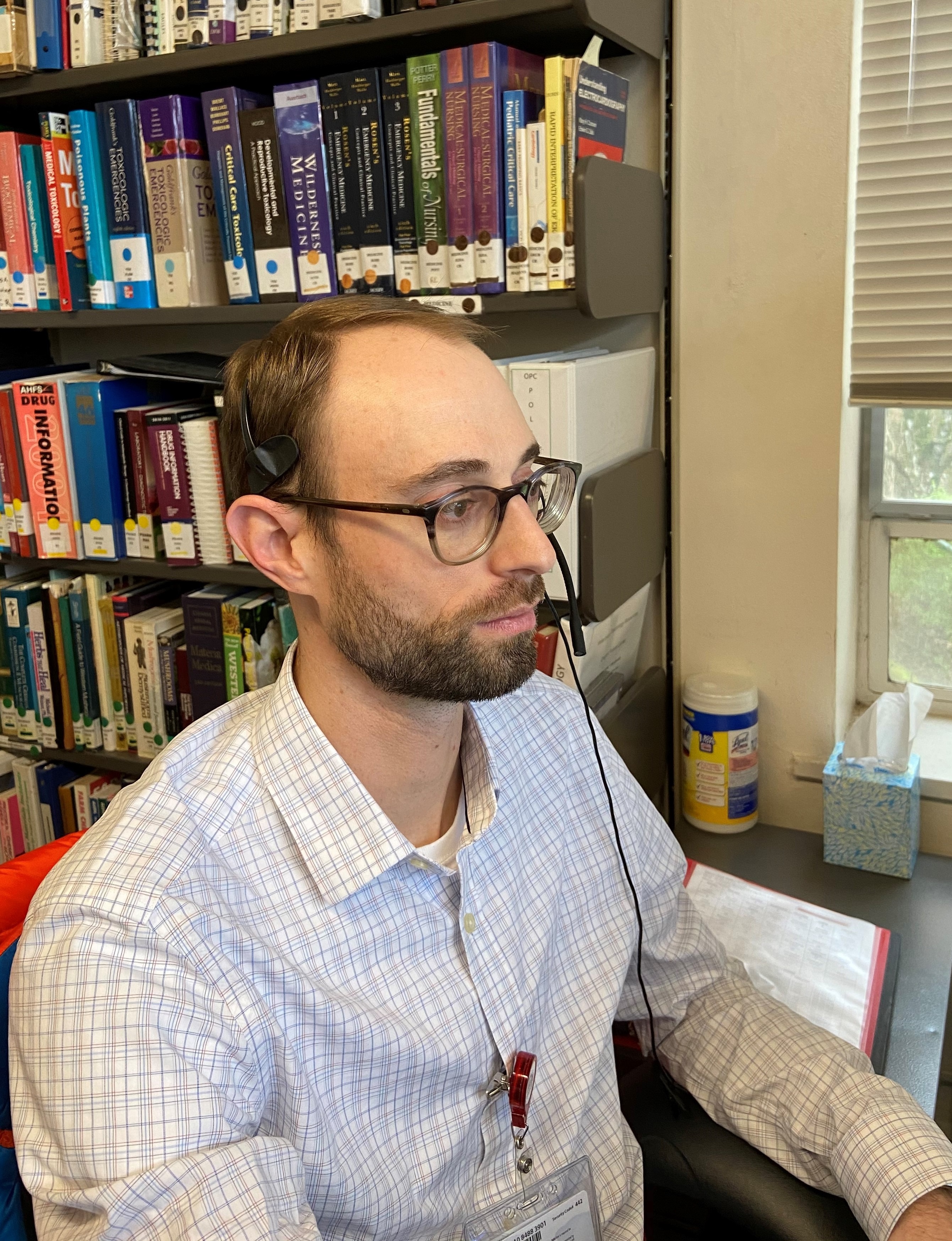 A poison specialist takes a call in in the poison center call room at OHSU