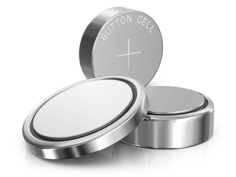 A trio of various sized button batteries shown against a white background 