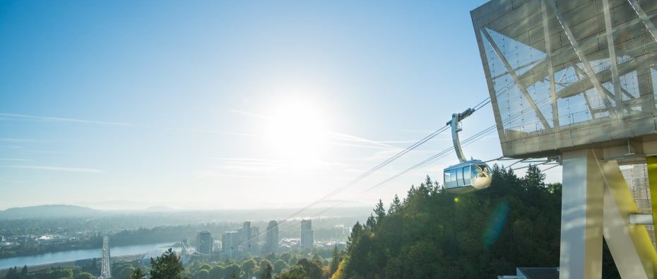 The OHSU tram descends on a sunny day, overlooking Portland.