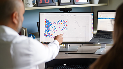 Occupational Public Health Program staff look at data on worker injuries in the state of Oregon.