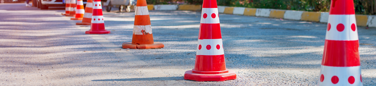 red street cones sign stands on asphalt road during car accident outside