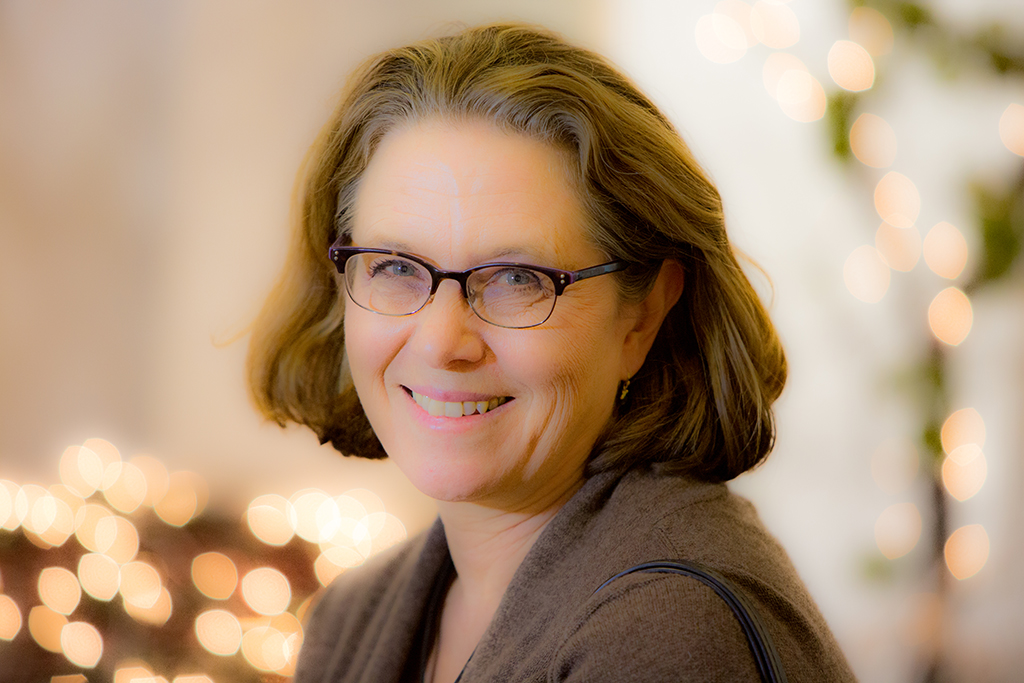 Headshot photo of Sigrid Button smiling at the camera