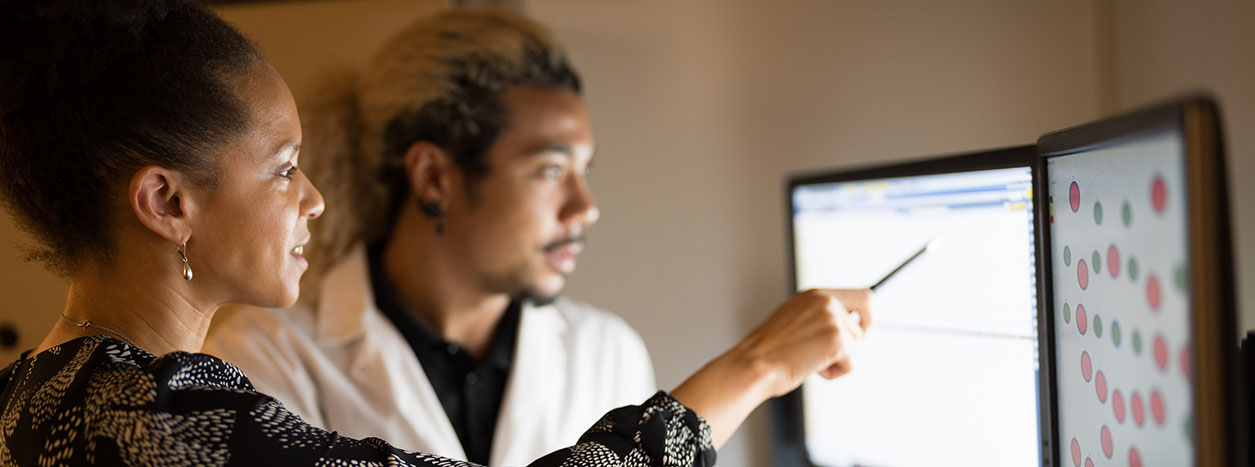 OccHealthSci researchers studying data on a computer.