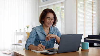 Woman taking an online training course at home on a laptop.