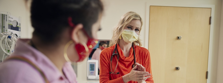 OHSU’s Dr. Marie Martinelli talks with a young person in an exam room.