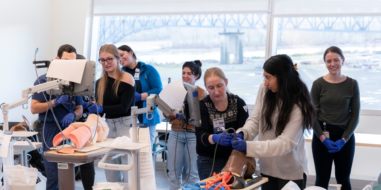 Students learning clinical skills on mannequins. 