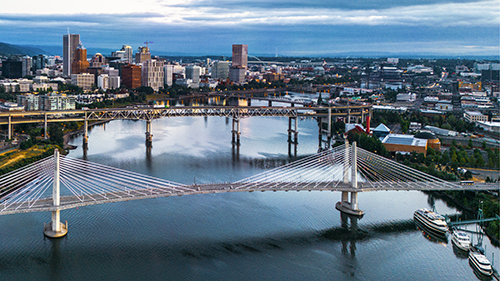 Overhead view of Portland and the Willamette River showing many of the city's bridges.