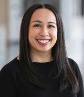 Headshot of a smiling woman with dark hair