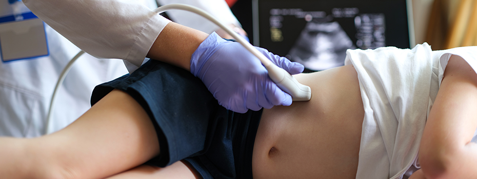 A provider giving an ultrasound exam on a child