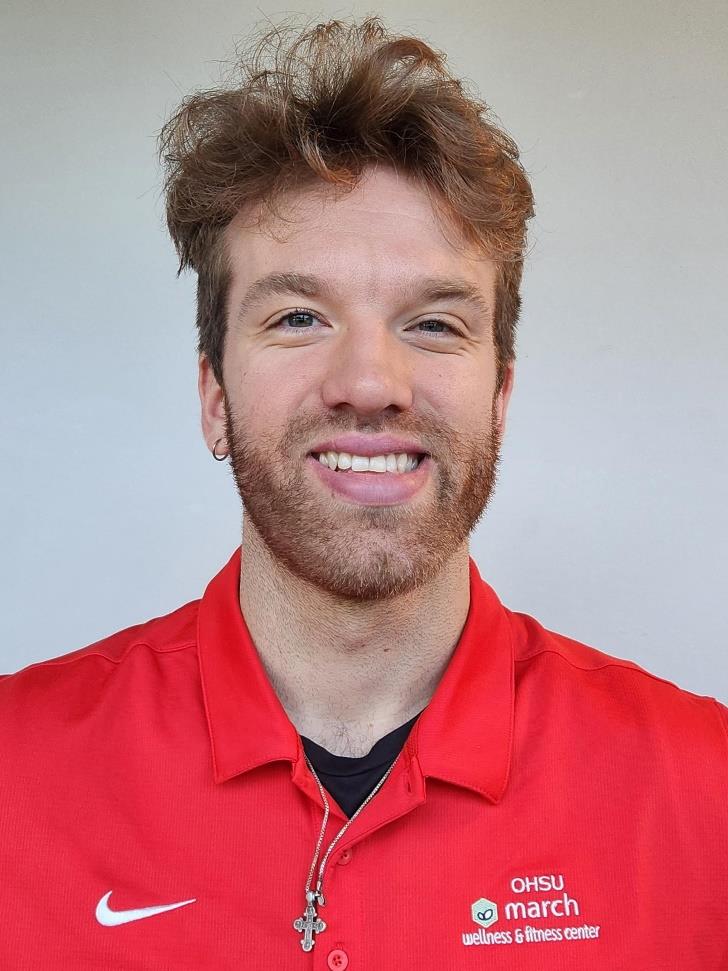 Picture of Aris Kitchin in a red march wellness polo shirt