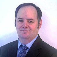 Professional headshot of Paul Millhouse