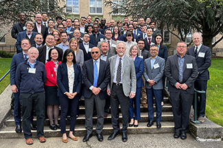 A group of approximately 50 doctors, trainers, residents and fellows standing on the steps in front of an academic building on OHSU campus in 2025.