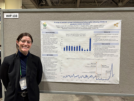 Duarte in front of presentation poster