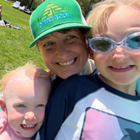 Dr. Sarah Green behind her two children, all three smiling.