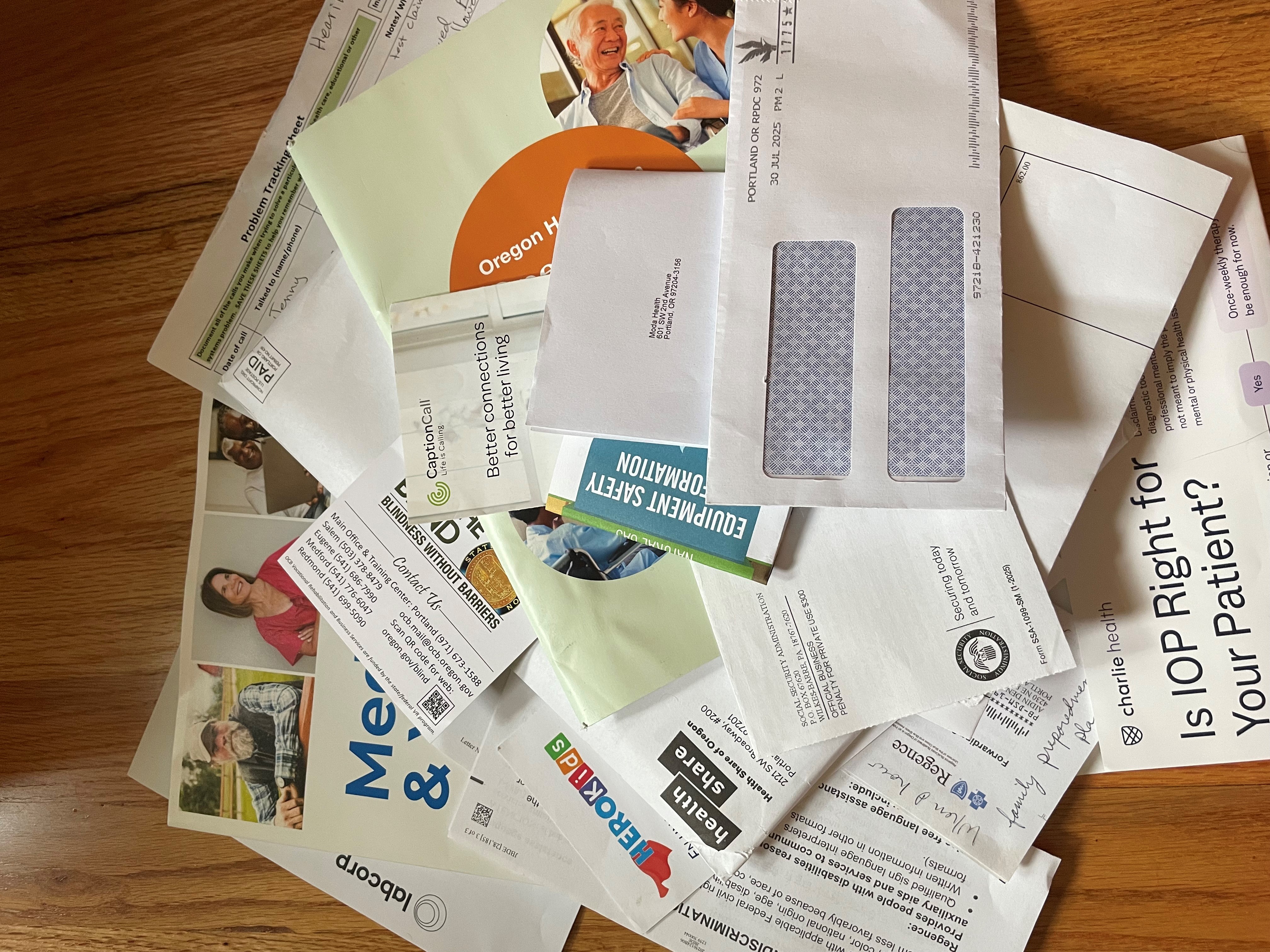 pile of insurance handbooks and paperwork related to health services