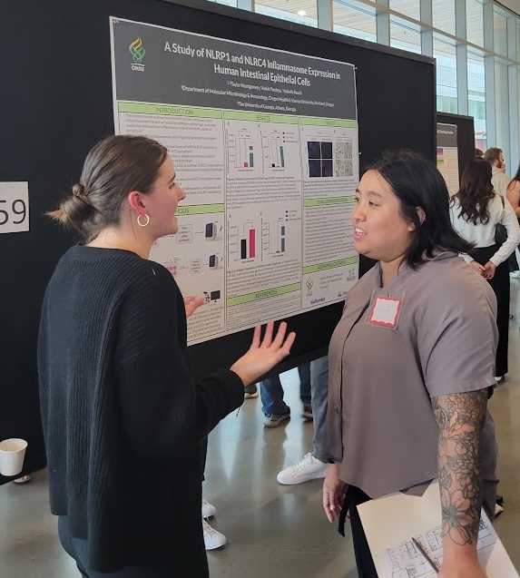 A student explaining a poster to someone